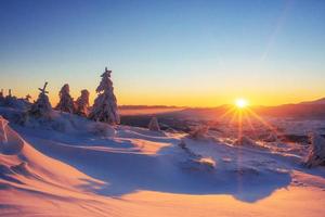 Mysterious winter landscape majestic mountains in  sunset. photo