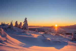 Mysterious winter landscape majestic mountains in  sunset. photo