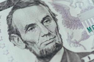 US President Abraham Lincoln face on five dollar bill macro photo