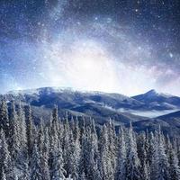 starry sky in winter snowy night. fantastic milky way in the New photo