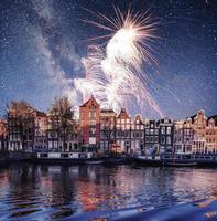 hermosa noche en amsterdam. iluminación de edificios y foto