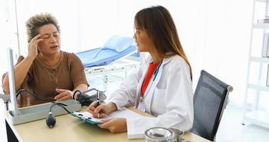 Doctor meeting and explaining medication to old woman patient at Hospitals photo