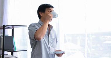 Senior Asian man drinking coffee on relaxing time photo