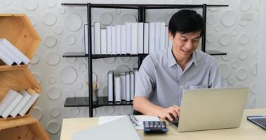 A senior Asian man using notebook for working and businesswoman serious about the work done until the headache