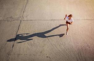 Top view of Asian Woman sprinting and runner working out in the city road photo