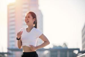smiling Asian Young fitness sport woman running  and Sportive people training in a urban area, healthy lifestyle and sport concepts photo