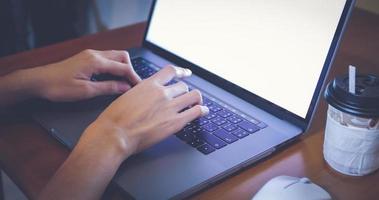 Asian woman is using a notebook computer for work at home and she is quarantine during the coronavirus epidemic. photo