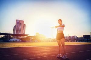 Asian woman checking her performance on watch before running photo