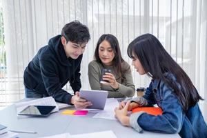 Group Students Smile and have fun and using tablet It also helps to share ideas in the work and project. And also review the book before the exam photo