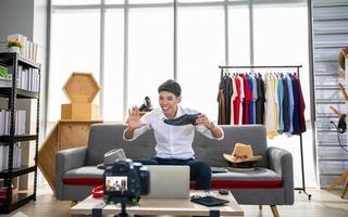 Asian man  blogger broadcasting a video for selling product online .Shopping online concept photo