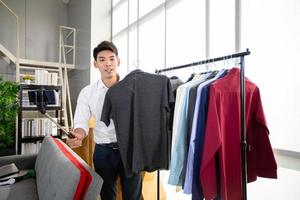 Asian man  blogger broadcasting a video for selling product online .Shopping online concept photo