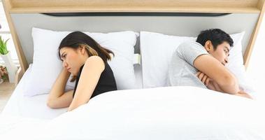 Asian Couple Having Problem in Bed and Frustrated couple with serious problems and Not Talking Feeling Offended or Stubborn photo