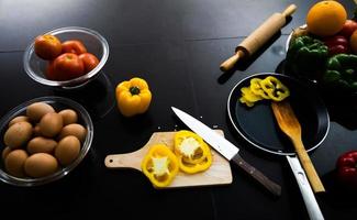 Food and fresh vegetables and salad bowls on kitchen table on top view .Healthy eating concept photo