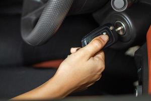 Woman 's hands hold the key for starting the car photo
