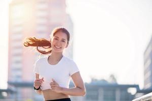 smiling Asian Young fitness sport woman running  and Sportive people training in a urban area, healthy lifestyle and sport concepts photo