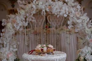 Wedding stand for rings. Wedding arch romantic decoration with flowers. photo