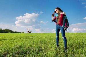 Young beautiful brunette woman with long hair in Ukrainian blouse in outdoor ethnic village in Kyiv Ukraine photo