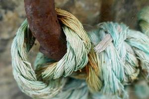 Blue Rope Tied to a Rusty Iron Ring photo