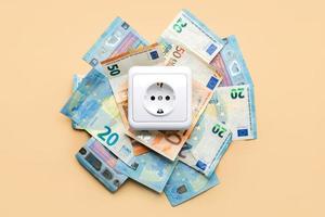 Electricity outlet socket with euro bills photo