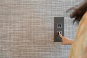 Woman calling the elevator. photo