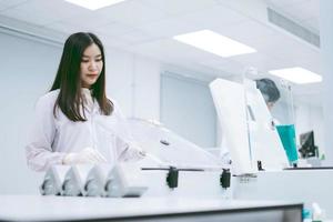young female scientists open centrifuge in medical laboratory photo