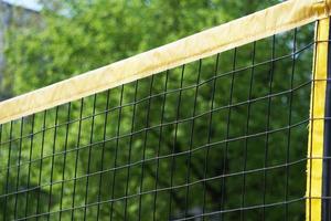 beach volleball net against trees photo