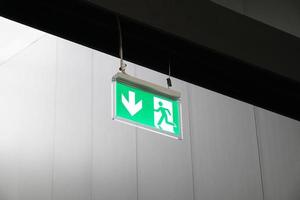 emergency exit or fire escape sign with running man symbol and arrow photo