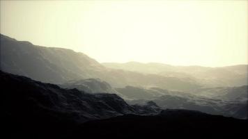 silhouette of swiss alps mountains in morning clouds photo