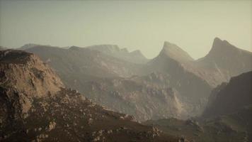 silhouette of swiss alps mountains in morning clouds photo