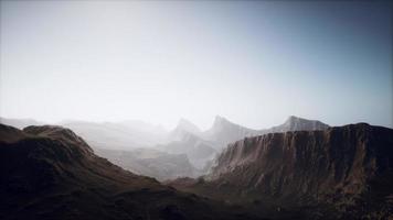 silhouette of swiss alps mountains in morning clouds photo