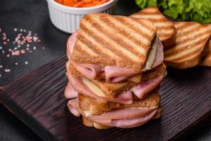 Delicious fresh toast grill with cheese and ham. Sandwiches, quick snack photo