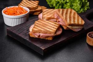 Delicious fresh toast grill with cheese and ham. Sandwiches, quick snack photo