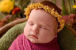 Close-up beautiful sleeping baby girl. Newborn baby girl, asleep on a blanket photo