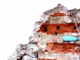 White wall of damaged ruined house has cement bricks and pipes. Construction and building concepts. photo