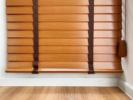 Brown wooden blinds on windows of rooms inside house. photo