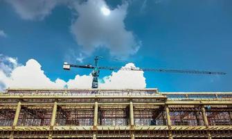 Construction of building and large crane daytime photo