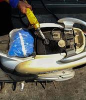 Motorcycles are refueling manually at this gas station. photo