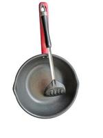 Isolated Old frying pan and utility turner, a cooking utensil on white background photo