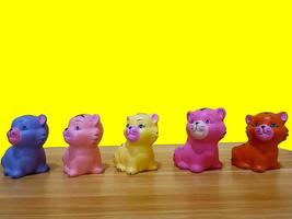 Small plastic colorful cat figures built on table photo