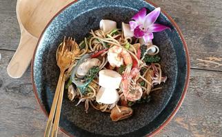 Black plate of seafood spaghetti with shrimp, squid, clams photo