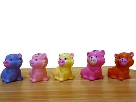 Small plastic colorful cat figures built on table photo