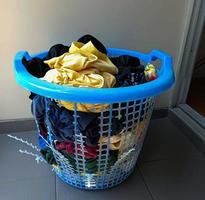 Broken blue plastic laundry basket. photo