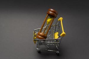 Small model shopping cart over black background studio photo