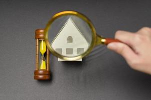 Small white model home over black background studio photo