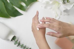 close up hand of applying moisturizing cream, skincare and beauty concept photo