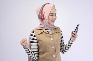 Young beautifu musliml woman wearing headset on white background photo