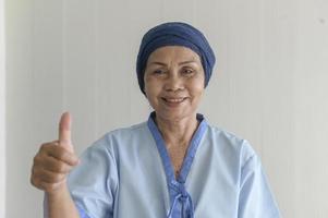 Portrait of senior cancer patient woman wearing head scarf in hospital, healthcare and medical concept photo