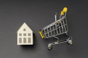 Small white model home over black background studio photo