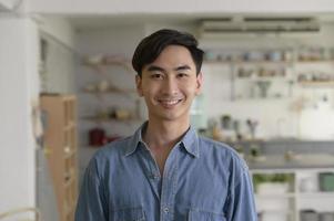 Portrait of young asian man in the living room at home photo