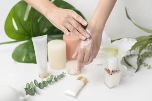 close up hand of applying moisturizing cream, skincare and beauty concept photo